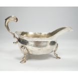 A George II silver sauceboat, with flying scroll handle, John Pollock, London, 1751, length 21cm,