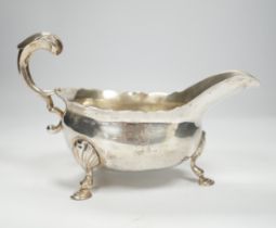 A George II silver sauceboat, with flying scroll handle, John Pollock, London, 1751, length 21cm,