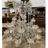 A moulded glass eighteen branch chandelier, hung circular and pear shaped faceted drops, height
