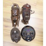 Four African tribal carved wooden masks, tallest 39 cm high