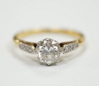 An 18ct, plat. and single stone diamond ring, with diamond set shoulders, the central stone