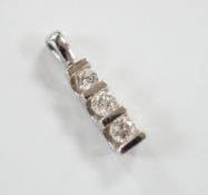 A modern 750 white metal and three stone diamond set pendant, 15mm, gross weight 0.9 grams.