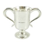 A George III provincial silver two handled pedestal cup, with engraved monogram, marks rubbed,