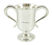 A George III provincial silver two handled pedestal cup, with engraved monogram, marks rubbed,