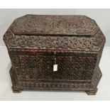 An Islamic octagonal carved wood trunk, width 116cm, depth 64cm, height 64cm, the cover carved “