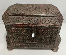 An Islamic octagonal carved wood trunk, width 116cm, depth 64cm, height 64cm, the cover carved “