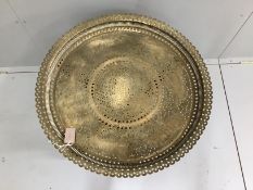 An Indian circular pierced brass tray top occasional table, diameter 69cm, height 65cm