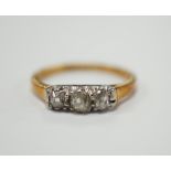 An 18ct, plat. and three stone diamond set ring, size K/L, gross weight 2.5 grams.