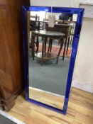 An Art Deco style rectangular blue glass bordered wall mirror, width 40cm, height 84cm