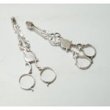 A pair of mid 18th century silver sugar nips, 12.3 cm and a pair of George V silver sugar nips.