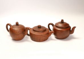 Three Chinese Yixing terracotta teapots, tallest 9cm