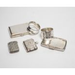 Two silver napkin rings, two silver cigarette cases and two silver vesta cases.