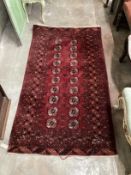 A Bokhara red ground rug, 188 x 104cm