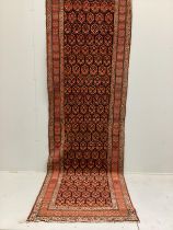 An Afshar blue ground runner woven with rows of floral devices, 354cm x 107cm