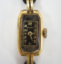 A lady's 1930's 18ct gold Eterna manual wind wrist watch, on a twin strand fabric strap with gold