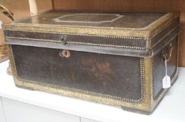 A 19th century leather and brass studded and mounted travelling trunk with metal and printed paper