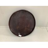 An African circular carved hardwood tray, diameter 66cm, height 10cm