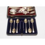 A cased set of six silver teaspoons and tongs and four other assorted silver or white metal