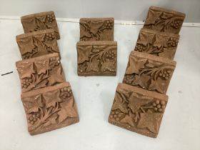 A set of ten cast terracotta fruiting vine corbels, each 23cm wide, depth 15cm, height 13cm