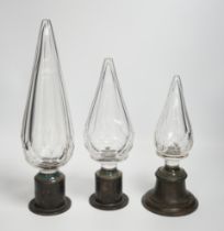 Three Large cut glass stoppers mounted on brass bases, highest 32.5cm