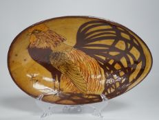 A Chelsea pottery slipware dish decorated with a cockerel, 27.5cm