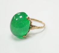 A 9ct and large cabochon oval jade set ring, size P/Q, gross weight 11.6 grams, the stone