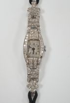 A lady's 1930's/1940's French white metal (platinum mark) and diamond cluster set manual wind