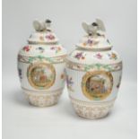A pair of Continental floral decorated ribbed jars and covers with figural cartouches, 32cm high