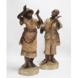 A pair of late 19th century Continental cold painted terracotta Nubian musician figures, 49cm