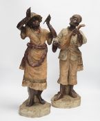 A pair of late 19th century Continental cold painted terracotta Nubian musician figures, 49cm