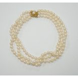 A triple strand cultured pearl set choker necklace, with 750 yellow metal and cultured pearl set