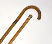An early 20th century sword stick and a metal topped cane, sword stick 91cm long