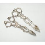 A pair of Victorian cast silver sugar tongs, of foliate design, by George Adams, London, 1871, 14.