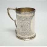 A Victorian engraved silver mug, with ornate handle, George Unite, Birmingham, 1869, height 12.