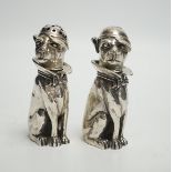 A novelty pair of 925 pepperettes, modelled as seated dogs, wearing caps, 76mm, 6.3oz.