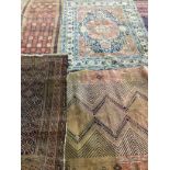 Four antique North West Persian and Caucasian rugs, largest 180 x 142cm