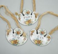 A group of three enamelled bottle labels - ‘rum’, ‘gin’ and ‘port’