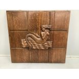 A rectangular carved oak mermaid plaque (formerly a cabinet door), width 81cm, height 75cm