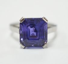 A white metal and single stone and square cut blueish purple sapphire set dress ring, size M,