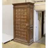 An early 20th century French oak notaries cabinet with twenty fall front compartments, width