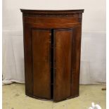 A 19th century George III bow-fronted hanging mahogany corner cupboard, width 84cm, depth 59cm,