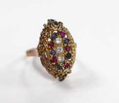 A 750 yellow metal, ruby, sapphire and diamond cluster set oval dress ring, size P, gross weight 9.3