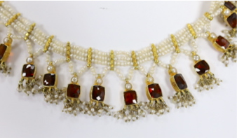 An Indian yellow metal mounted triple strand seed pearl and graduated twenty stone garnet set drop - Image 2 of 2