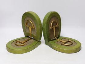 A pair of Asprey green leather and brass stirrup book-ends, 19.5cm