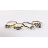 Four assorted 18ct and diamond set rings, including two three stone, a five stone and solitaire,