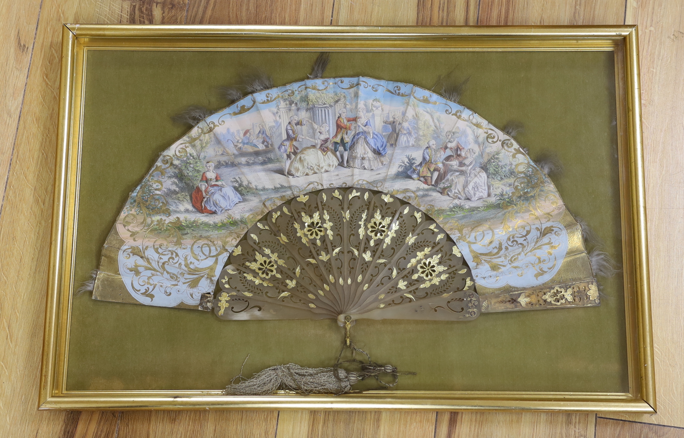 A 19th century fan, hand painted with figures wearing 18th century dress, framed, 57 x 37cm