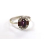 A modern Art Deco style 9ct white gold, amethyst and diamond chip set cluster ring, size Q/R,