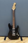 A cased Squier Strat by Fender electric guitar with rosewood neck and balance lacquer body, together