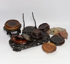 A collection of Chinese hardwood stands and a soapstone example, largest 29cm wide