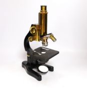 An early 20th century Leitz microscope in a teak case, with alternative lenses, card inserts and